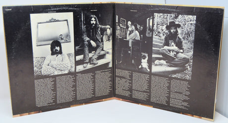 Open record gatefold with black and white photos and text.