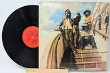 Vinyl record with colorful cover art featuring people on steps.