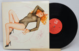 Used vinyl record of The Cars - Candy-O with the album cover showing a sketch of a sexy red headed woman lying across the hood of a car.