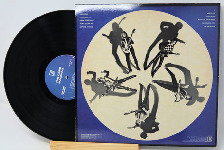 Vinyl record with a blue and beige cover featuring black silhouette art of a musician playing guitar.