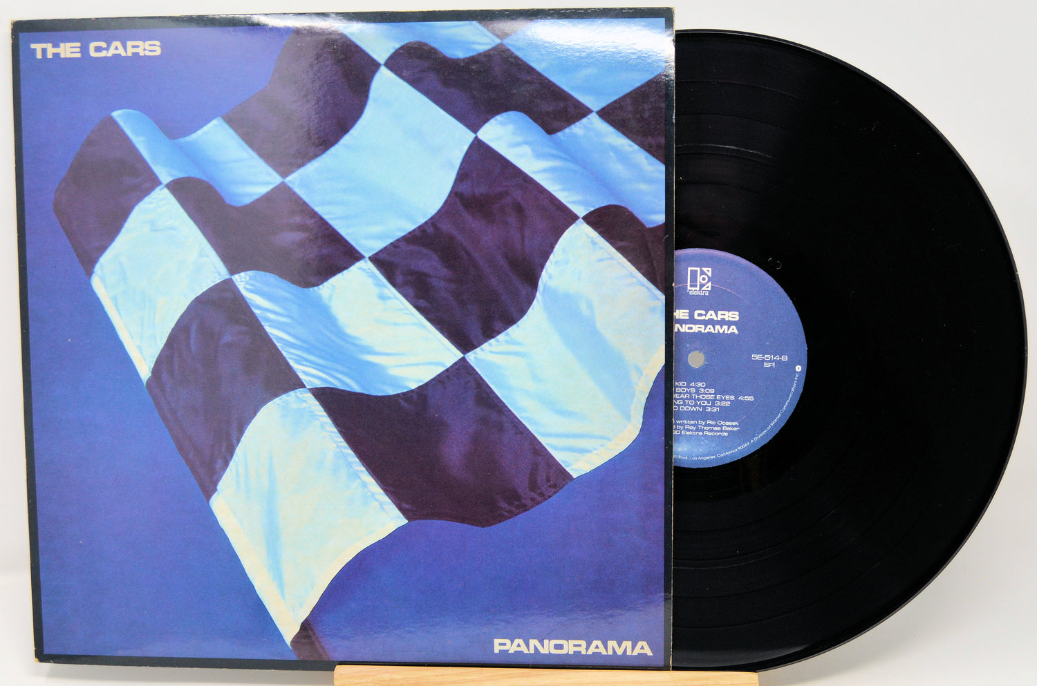 Vinyl record with a checkered flag design on the cover, featuring the band 'The Cars' and album 'Panorama'.