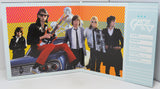 Music album cover with band members and colorful background