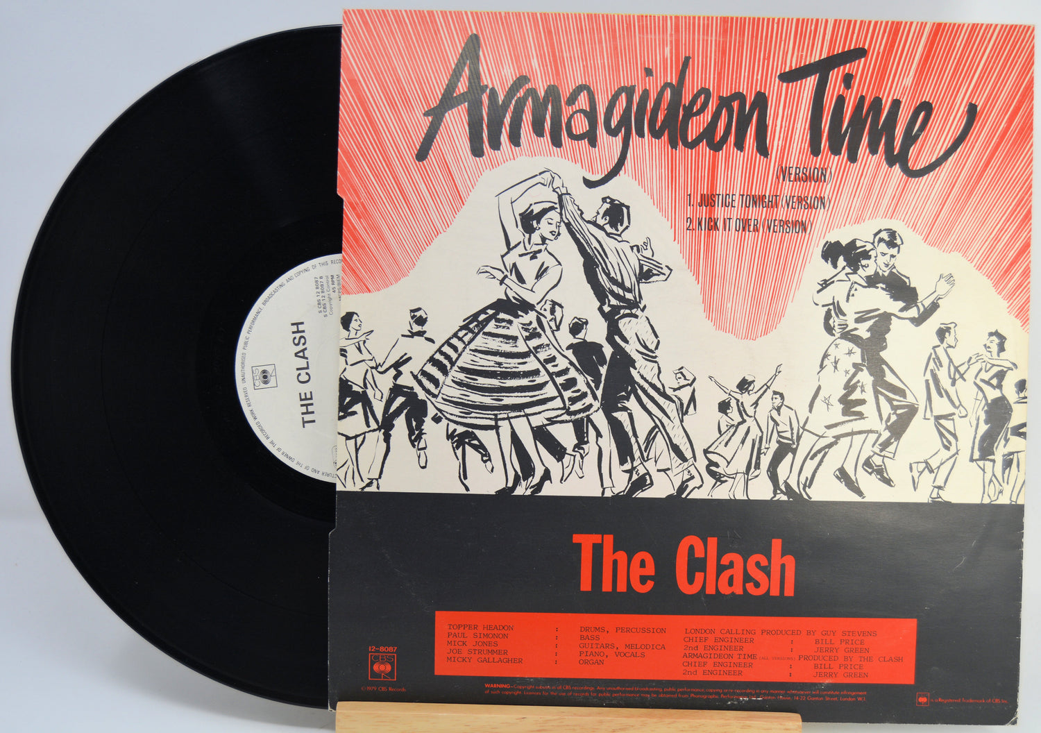 A vinyl record partially pulled from its sleeve for the Clash's 'Armagideon Time' album, photographed against a plain light background.
