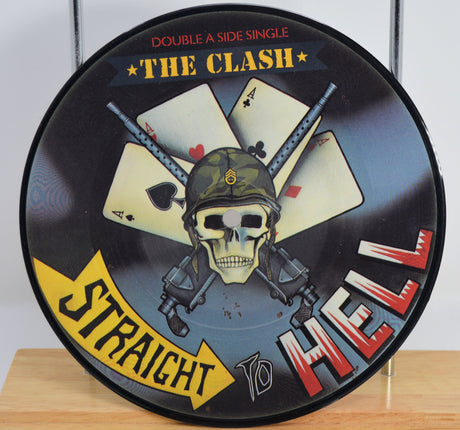 The Clash 'Should I Stay or Should I Go' Vinyl Picture Disc with skull and cards design, featuring 'Straight To Hell' text.