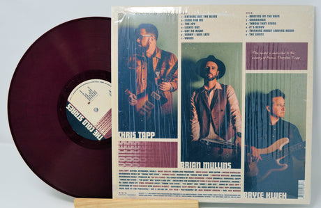 Back cover and burgundy plum vinyl of The Cold Stares' Voices album with band lineup and tracklist