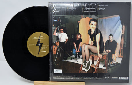 Back cover and vinyl record of The Cranberries Remembering Dolores 2LP featuring band members' photo and tracklist