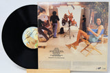 Vinyl record with cover showing a scene from a movie or TV show, featuring people in a room.