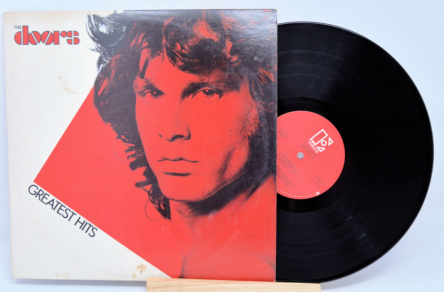 Vinyl record and cover with a stylized portrait on a light blue background