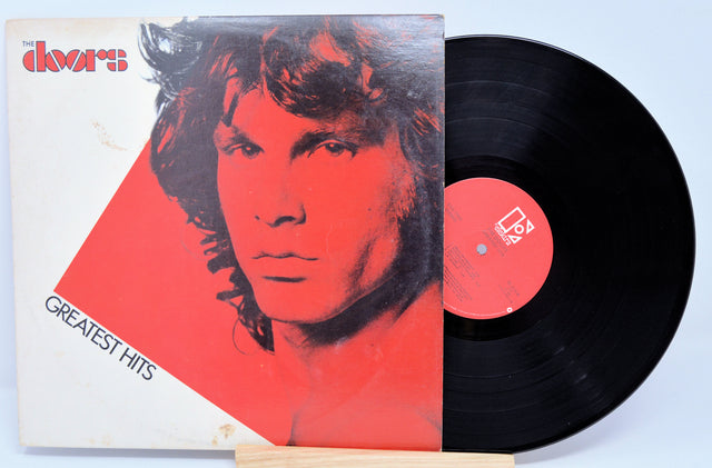 Vinyl record and cover with a stylized portrait on a light blue background