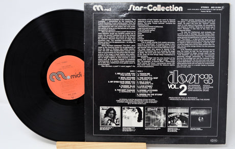 Back cover and vinyl record of The Doors Star Collection Vol. 2 displaying tracklist and liner notes