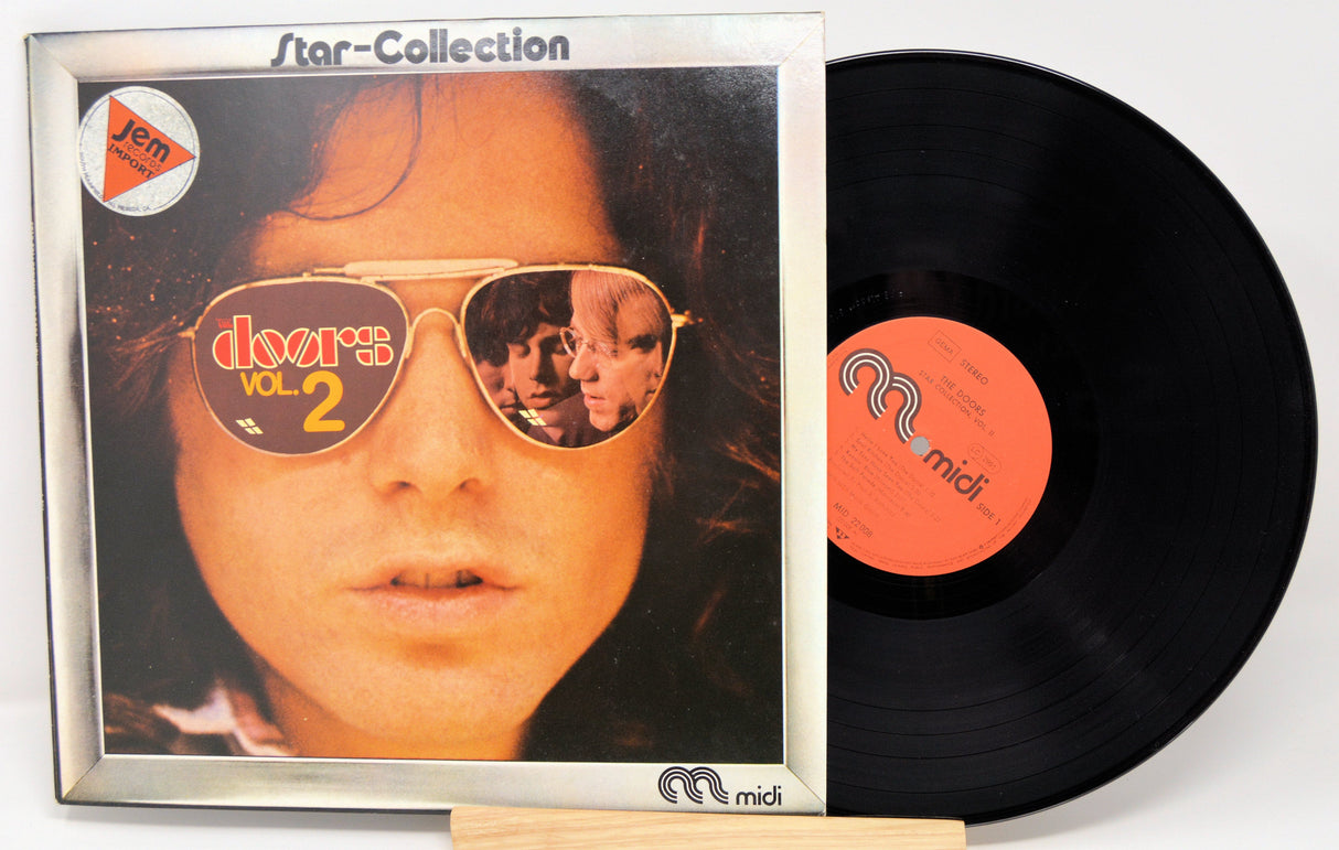 Front cover of The Doors Star Collection Vol. 2 LP with reflection of band members in sunglasses and vinyl record