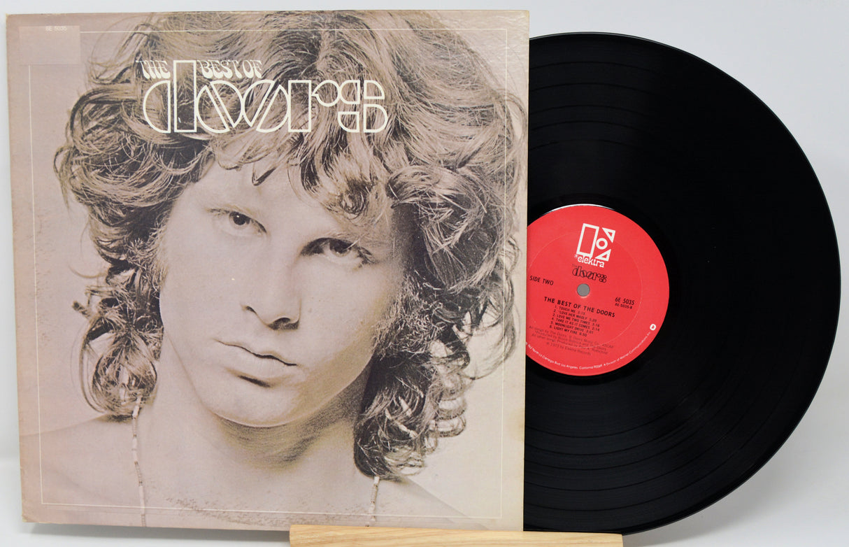 Vinyl record with a portrait on the cover and a red label