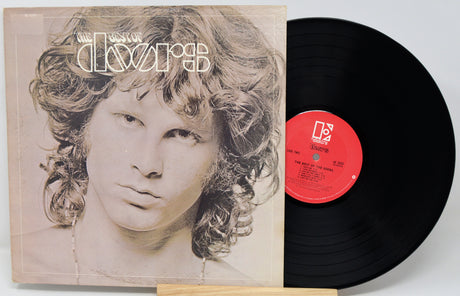 Vinyl record with a portrait on the cover and a red label