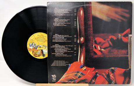 Vinyl record with cover featuring a musical instrument and text