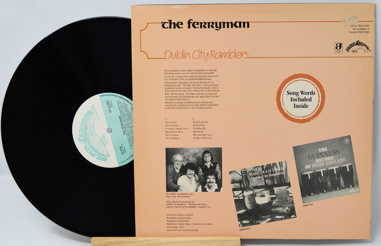 Vinyl record with its cover featuring text and images of people.
