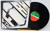 Vinyl record with a black cover featuring geometric design and a visible label.