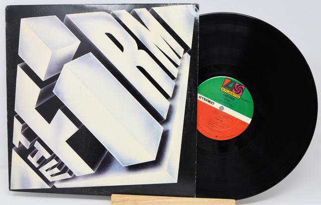Vinyl record with a black cover featuring geometric design and a visible label.