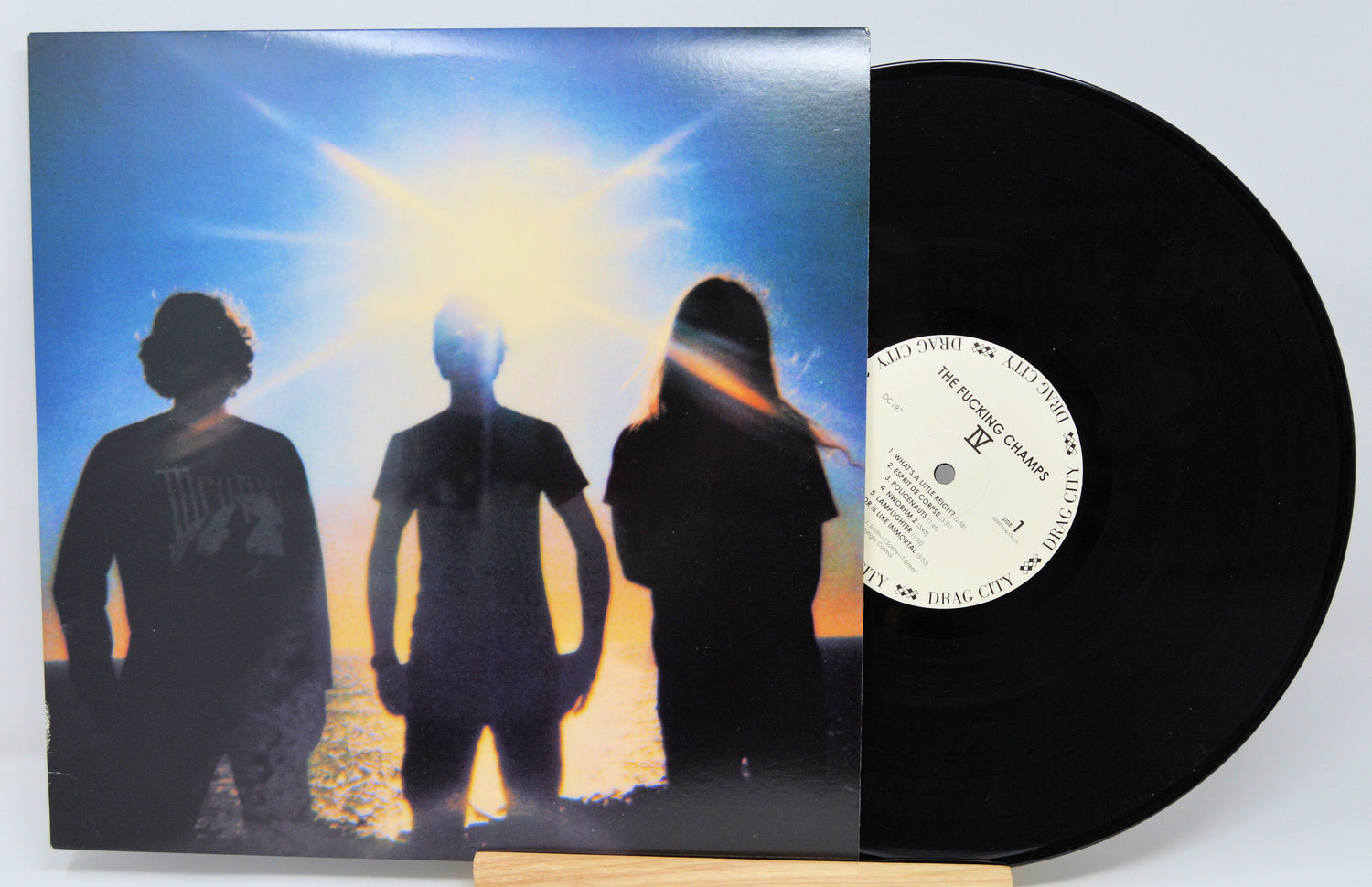 The Fucking Champs IV album cover showing three silhouetted figures against a bright sun