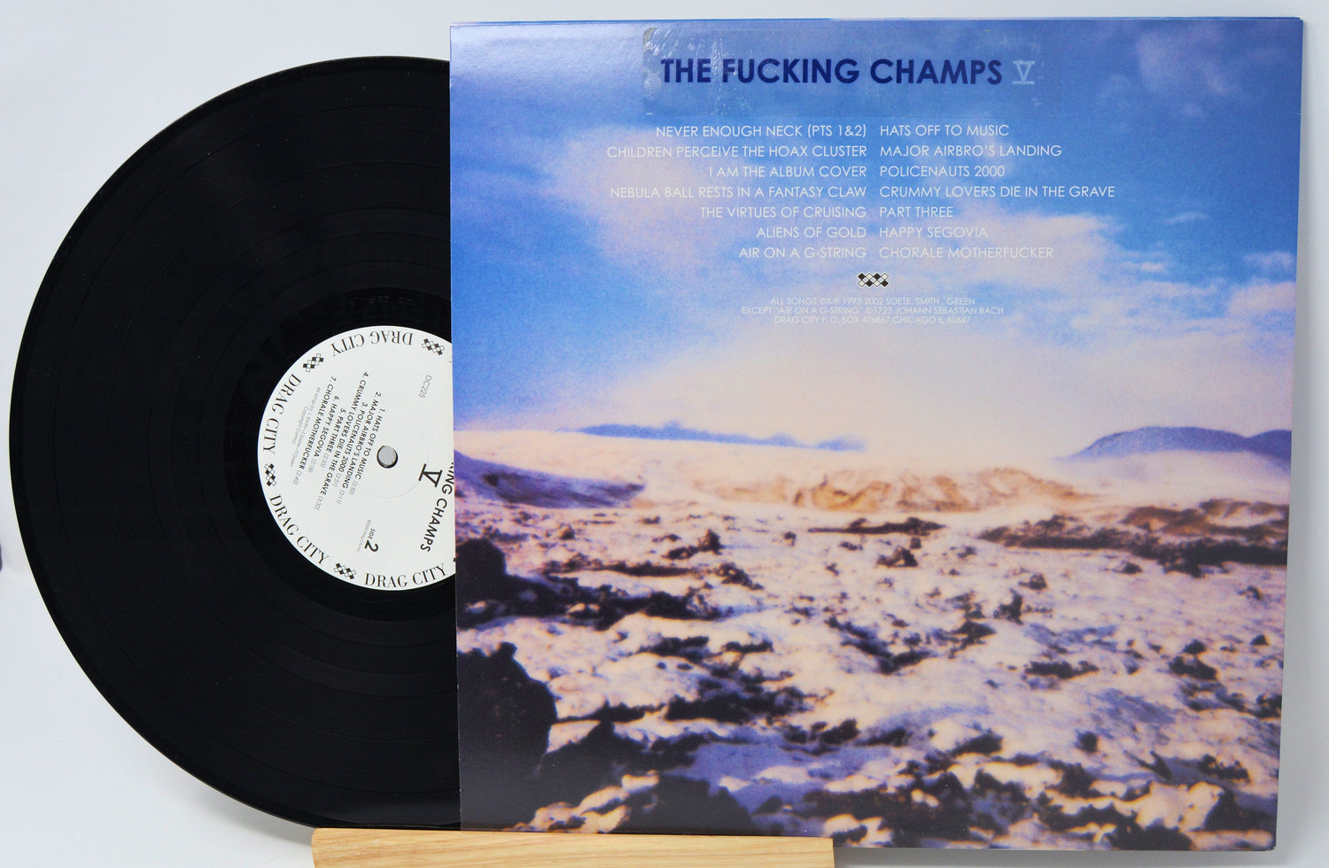 Back cover and vinyl of The Fucking Champs V LP with tracklist over icy landscape