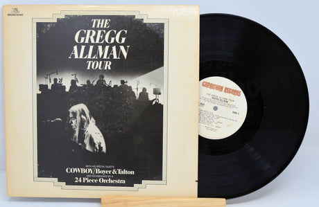 Vinyl record with cover featuring 'The Gregg Allman Tour' on a light blue background