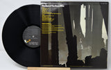 Vinyl record with cover featuring a silhouette design on a white background