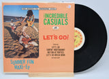Front cover of The Incredible Casuals Let's Go! maxi-EP vinyl featuring band on the beach