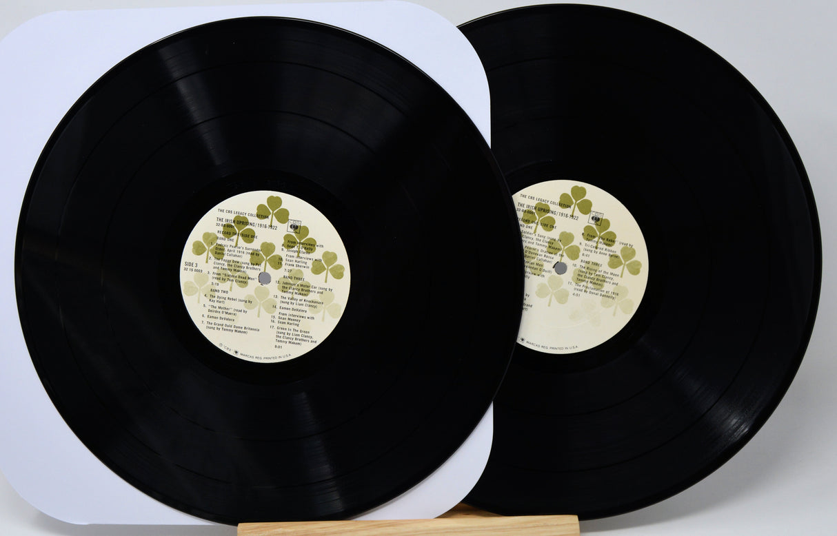 Two vinyl records with labels on a white background