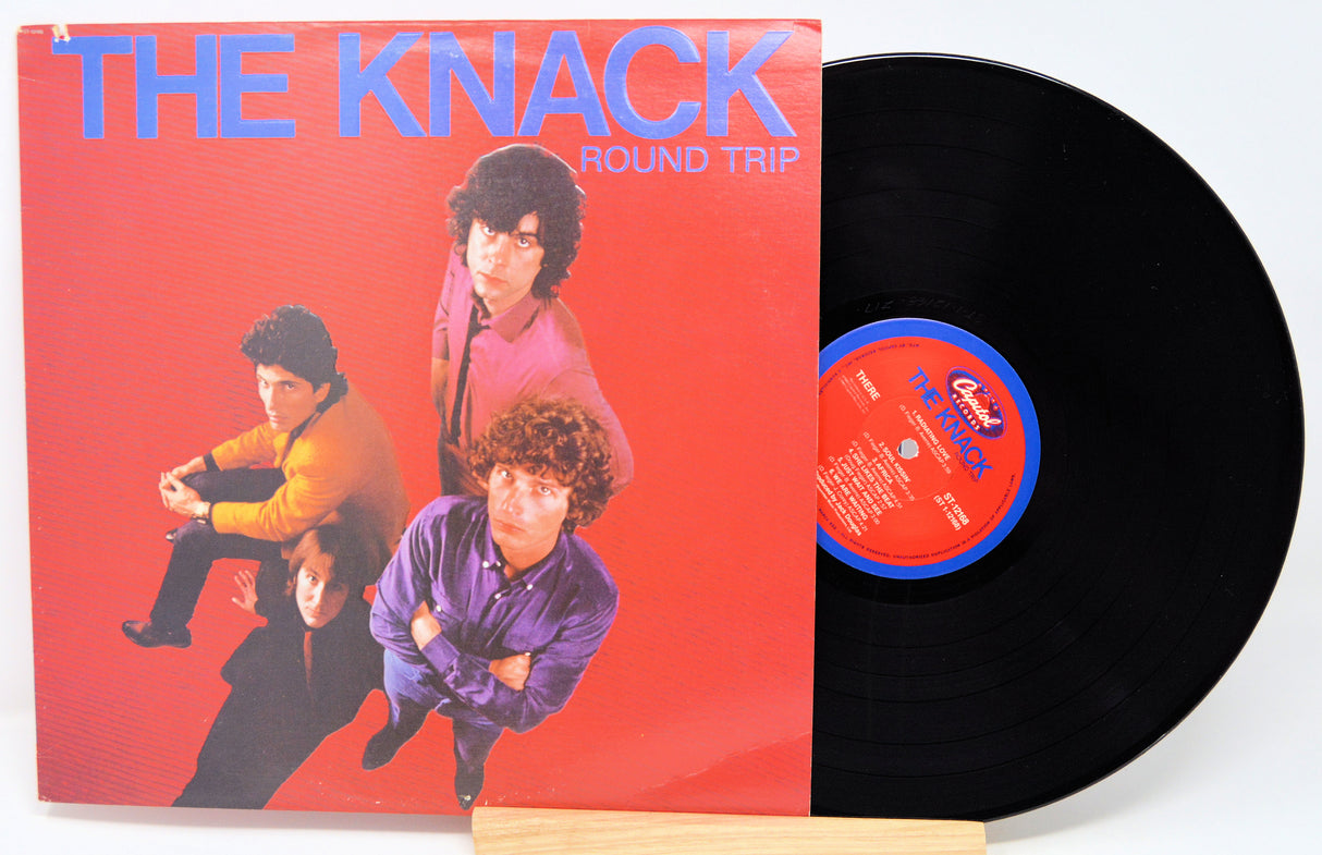 Vinyl record with 'The Knack' album cover showing four band members on a red background.