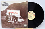 Front cover of The Last Mile Ramblers – While They Last! vinyl LP, featuring the band by a vintage car and album title