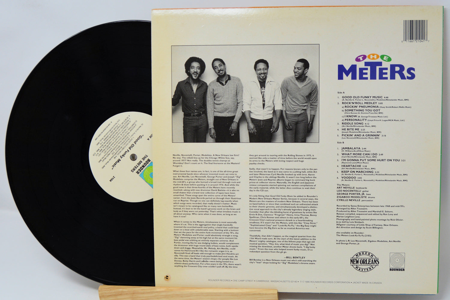 Vinyl record with cover featuring a band photo and text on a light gray background
