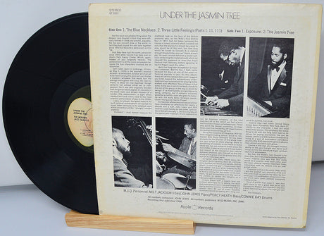 Back cover of 'Under the Jasmin Tree' LP by The Modern Jazz Quartet showing liner notes, band photos, and tracklist