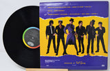 Vinyl record with a colorful cover featuring a group of people on a yellow background