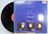 Vinyl record with blue cover featuring text and individual images of the three band members.