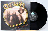 Vinyl record with 'Outlaws' album cover featuring a band portrait.