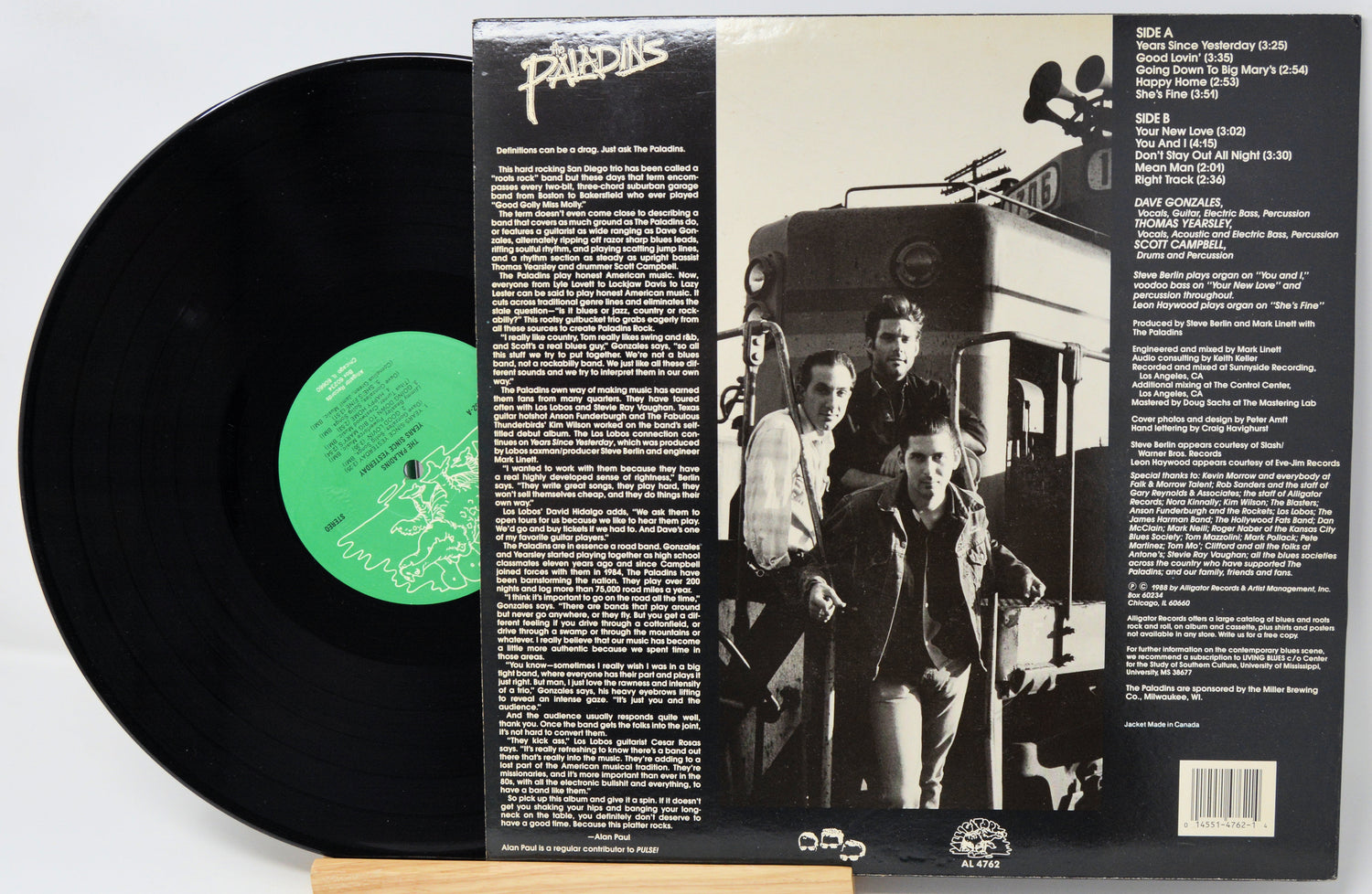 Vinyl record with green label and its cover showing a black and white photo of two men and text.