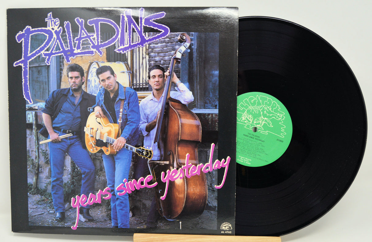 Vinyl record with cover featuring musicians and text 'The Paladins years since yesterday' on a white background.