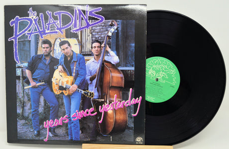 Vinyl record with cover featuring musicians and text 'The Paladins years since yesterday' on a white background.