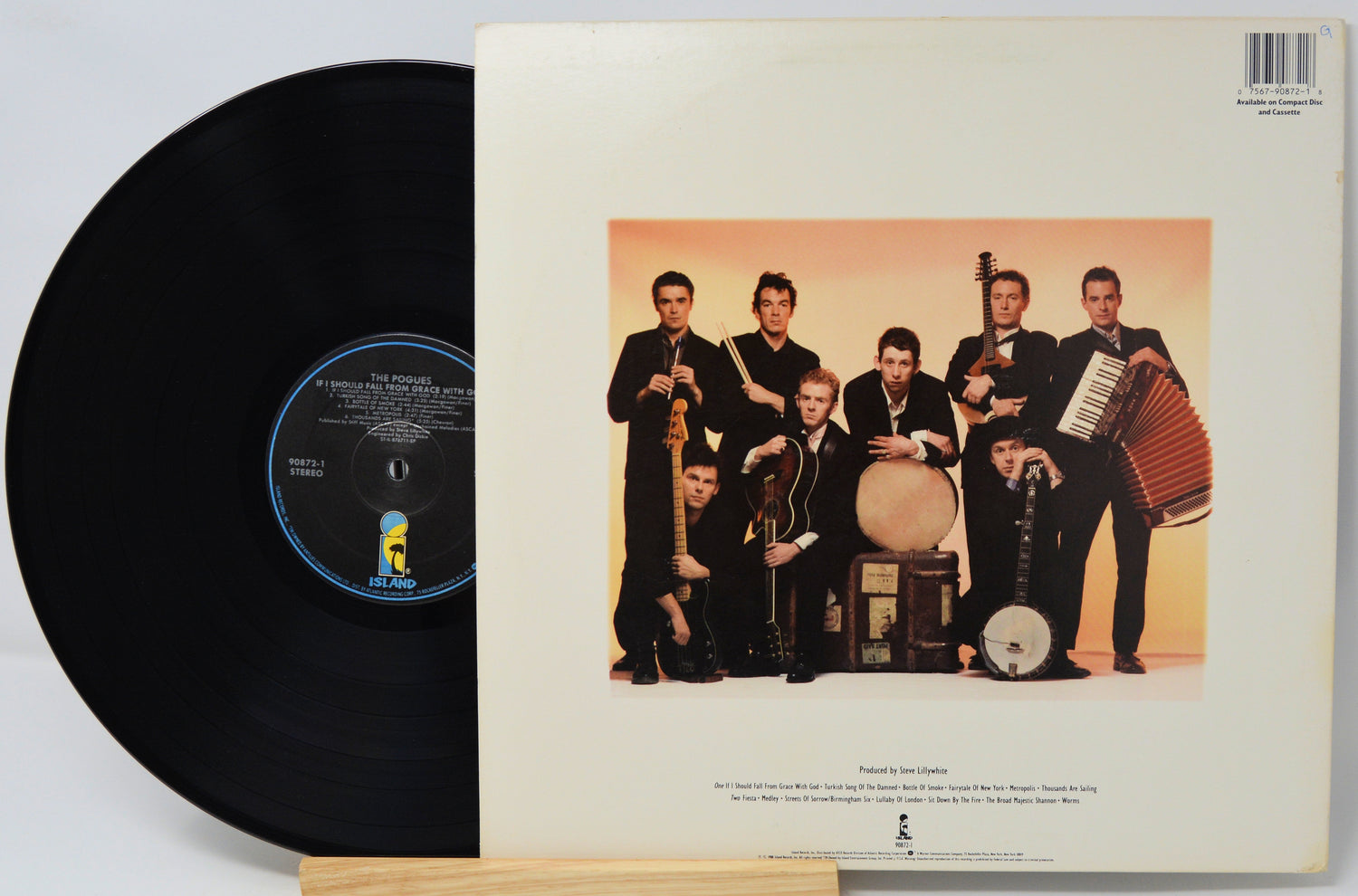 Vinyl record with cover featuring a band posing with instruments on a beige background