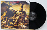 Vinyl record and cover of 'Rum O'Clock and the Lash' by The Pogues on a white background
