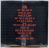 The back cover of a vinyl record featuring a black background with the tracklist printed in red and yellow text, wrapped in clear plastic.