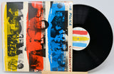 The Police 'Synchronicity' vinyl record LP with its illustrated outer sleeve partially covering the black record, photographed on a light gray background.