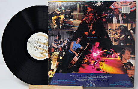 Vinyl record with a colorful album cover featuring musicians and a bar setting.