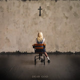Person sitting on a chair in front of a textured wall with a cross, titled 'Dear God'.