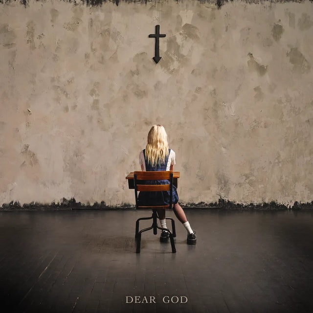 Person sitting on a chair in front of a textured wall with a cross, titled 'Dear God'.