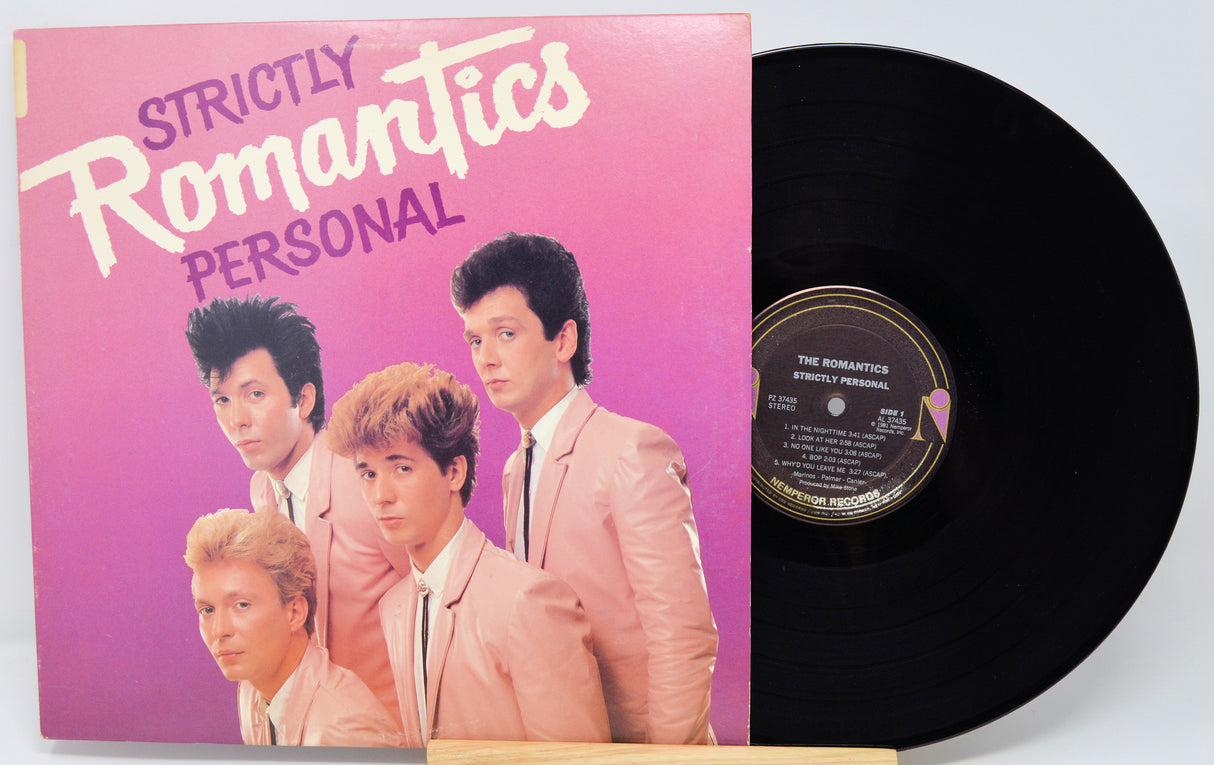 Vinyl record with 'Strictly Romantics' album cover featuring four band members.