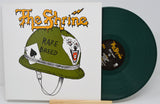 The Shrine Rare Breed LP cover art with green military helmet, wolf graphic, and vinyl record partially visible
