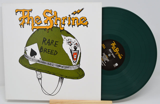 The Shrine Rare Breed LP cover art with green military helmet, wolf graphic, and vinyl record partially visible