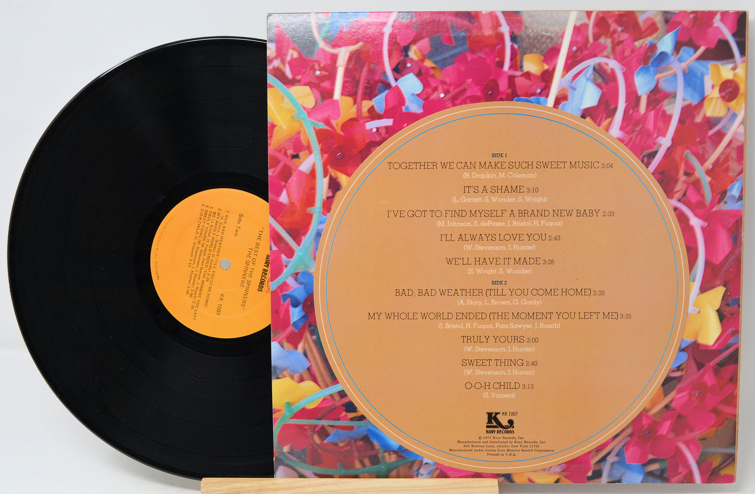 Vinyl record with colorful cover and black disc on a white background