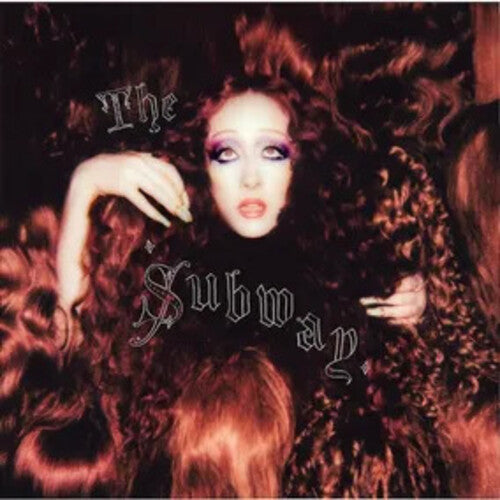 Glamorous woman surrounded by luxurious curls with 'The Subway' album title in stylized font