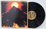 The Sun Awakens album cover with glowing sun over mountain by Six Organs of Admittance on vinyl
